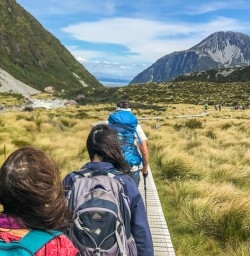 Group walking the Hooker Valley Track, Aoraki Mt Cook Canterbury New Zealand