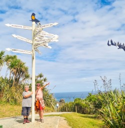 6. Two guests next to distance sign West Coast