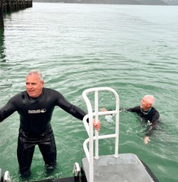 7. Guests climbing out of water dolphin swim
