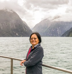 Lady on the boat at Milford Sound, Fiordland New Zealand