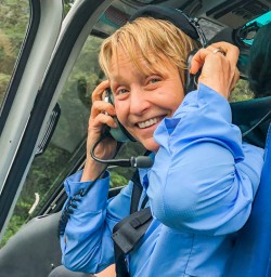 Lady in the helicopter at Milford Sound, Fiordland National Park Southland New Zealand