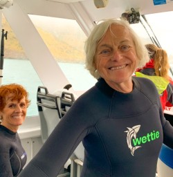 8. Happy guests on dolphin swim boat