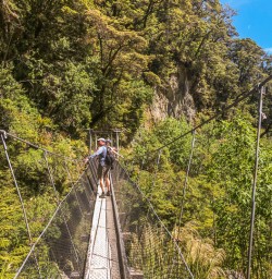 Crossing bridge at Routeburn track, Otago New Zealand