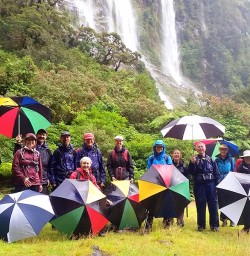 happy hiking group with umbrellas