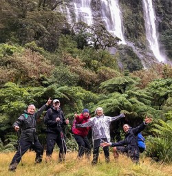 Group at Milford Track falls, Fiordland New Zealand