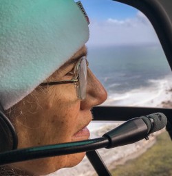 Guest in the helicopter at Fiordland, New Zealand