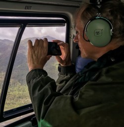 Guest in the helicopter at Fiordland, New Zealand