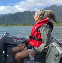 Guest on Jetboat at Hollyford river, Fiordland New Zealand