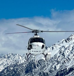 Helicopter ride through the snowcapped mountains. jpg