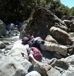 Hiker resting by river