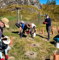 Guests planting trees in Arrowtown 060125