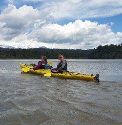 Kayak on Okarito Lagoon with Southern Alps in distance