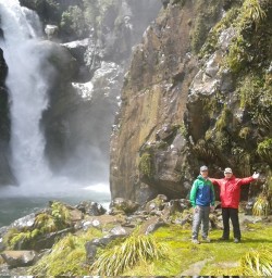 Walkers in front of Hidden Falls on the Hollyford Track