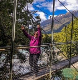 Happy lady crossing the Makarora river, Otago New Zealand