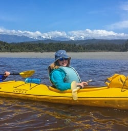 Couple kayaking at Okarito Lagoon, West Coast New Zealand
