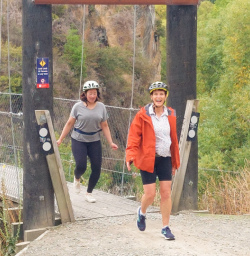 2. Two guests cross bridge on Arrow River Trail