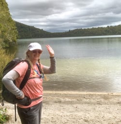 4. Solo guest waving by lake