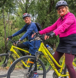 Couple biking the Arrow River Bridge Ride, Otago New Zealand