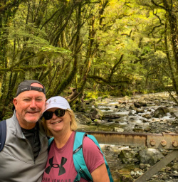 Happy guest couple on Milford Track great natural bush greenery