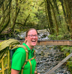 Happy guide Milford track bridge and native bush