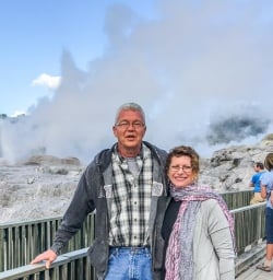Couple at Pohutu Geyser at Rotorua, Bay of Plenty New Zealand