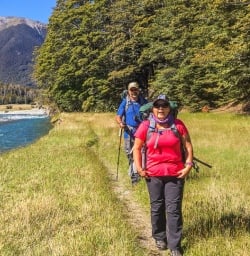 Couple walking along Travers river, Tasman New Zealand