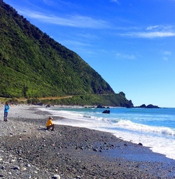hikers at west coast beach new zealand