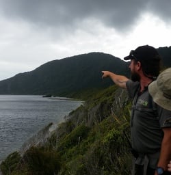 Guide and Hikers on the Fiordland Coast