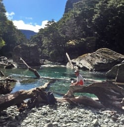 Walker resting by the Routeburn River
