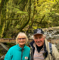 Happy guest couple Milford track natural bush