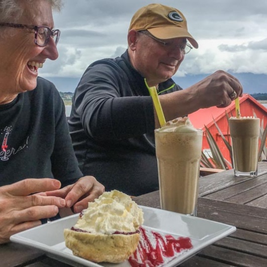 Couple having coffee at Moana, West Coast New Zealand