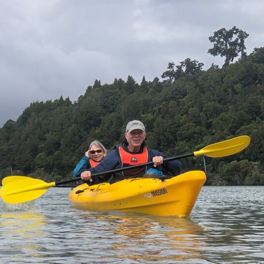 Couple kayaking at Okarito Lagoon, West Coast New Zealand