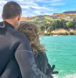Couple enjoying the colours on the boat Akaroa