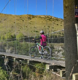Crossing the Arrowtown Gibbston trail swing bridge