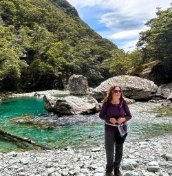 female guest by the water on the Routeburn Track