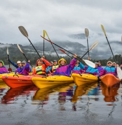 Group kayaking at Okarito Lagoon, West Coast New Zealand