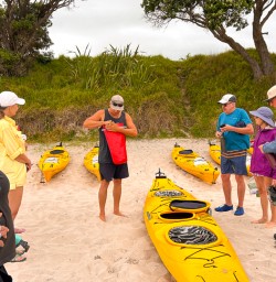 guests getting ready to kayak Cathedral Cove SN24FEB26