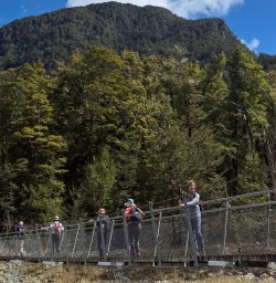 guests hiking on Routeburn Track bridge GW09NOV25