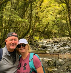 Happy guest couple on Milford Track great natural bush greenery