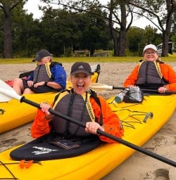 happy guests kayaking Cathedral Cove SN10MAR26