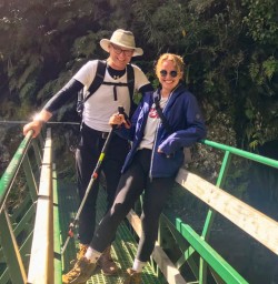 Happy guests with small waterfall on the Milford Track