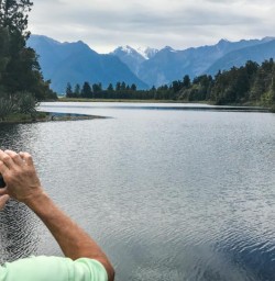 Taking picture at Lake Matheson, West Coast New Zealand